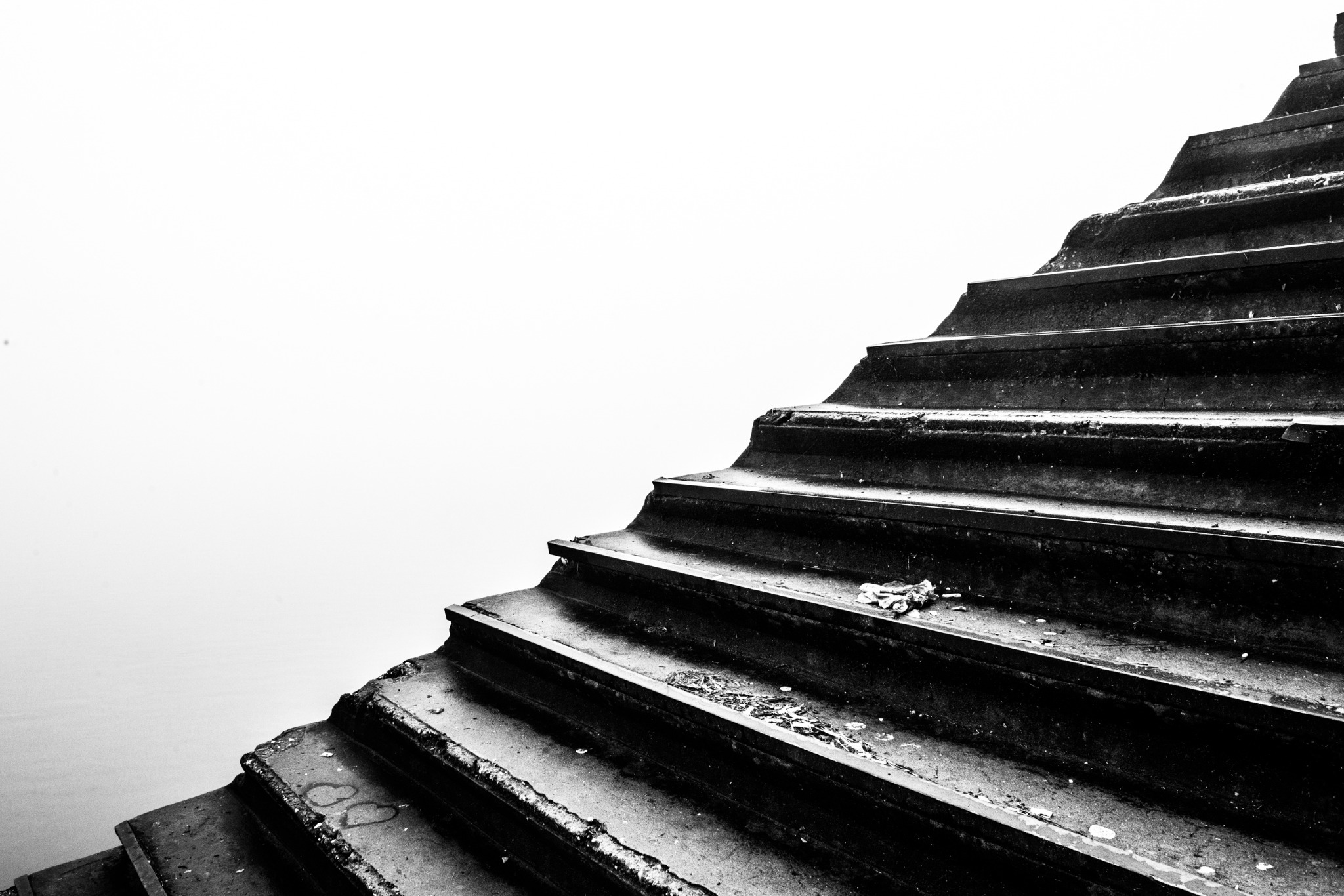 Dark stone steps rising towards a white sky