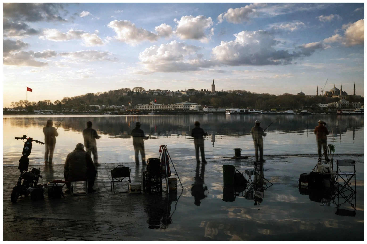 Silhouettes of anglers and reflections beside the Bosphorus