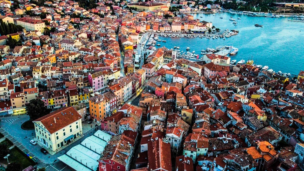 An aerial view of the rooftops and harbour of Rovinj